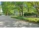 View of the neighborhood streetscape, lush trees, greenery, and a glimpse of the home at 108 Augusta Dr, Statesville, NC 28625