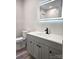 Modern bathroom with a vanity, lighted mirror, and toilet; featuring sleek fixtures and stylish design at 11 N 10Th Ave, Maiden, NC 28650