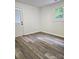A sunlit bedroom featuring modern wood laminate flooring and a freshly painted interior at 11 N 10Th Ave, Maiden, NC 28650