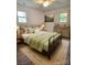 Cozy bedroom with warm lighting and a serene ambiance with two bright windows at 11 N 10Th Ave, Maiden, NC 28650