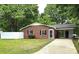 Charming single-story brick home featuring a well-manicured lawn and a convenient carport at 11 N 10Th Ave, Maiden, NC 28650