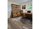 Inviting home office featuring a spacious desk, a large bookshelf, and stylish decor and wood laminate flooring at 11 N 10Th Ave, Maiden, NC 28650