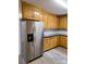 The kitchen features stainless steel appliances, light wood cabinets, black countertops and modern laminate flooring at 11 N 10Th Ave, Maiden, NC 28650