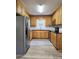 A bright kitchen featuring stainless steel appliances, light oak cabinets, black countertops and modern flooring at 11 N 10Th Ave, Maiden, NC 28650