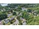 Aerial view of neighborhood showcasing mature landscaping near community tennis court at 111 Wilton Pl, Mooresville, NC 28117