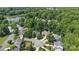 Aerial view of neighborhood featuring lakefront homes surrounded by mature trees at 111 Wilton Pl, Mooresville, NC 28117