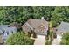 Aerial view of a brick home with a well-manicured lawn, mature trees and an attached two car garage at 111 Wilton Pl, Mooresville, NC 28117