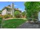 Expansive backyard features a well-manicured lawn and mature trees, perfect for recreation and relaxation at 111 Wilton Pl, Mooresville, NC 28117