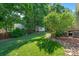 Serene backyard featuring lush green grass, mature trees, and a storage shed, creating a private retreat at 111 Wilton Pl, Mooresville, NC 28117