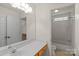 Well lit bathroom features a sink with vanity, a large mirror, and a shower-tub combination at 111 Wilton Pl, Mooresville, NC 28117