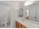Bright bathroom features a wood vanity, a large mirror and a separate toilet and shower room at 111 Wilton Pl, Mooresville, NC 28117