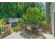 Inviting deck with table and chairs overlooks the landscaped backyard, perfect for outdoor dining at 111 Wilton Pl, Mooresville, NC 28117