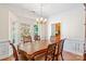 Elegant dining room with bay window, chandelier, and views into the kitchen at 111 Wilton Pl, Mooresville, NC 28117