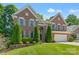 Charming brick home with lush front lawn, tasteful landscaping, and gray shutters at 111 Wilton Pl, Mooresville, NC 28117