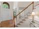 Grand foyer featuring a staircase and lots of natural light, making a striking first impression at 111 Wilton Pl, Mooresville, NC 28117