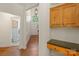 Convenient hallway with laundry area and built-in desk, enhancing functionality and organization at 111 Wilton Pl, Mooresville, NC 28117
