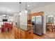 Open kitchen features granite counters, stainless appliances, and island with seating at 111 Wilton Pl, Mooresville, NC 28117