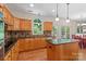 Well-equipped kitchen with custom cabinetry, island, and hardwood flooring at 111 Wilton Pl, Mooresville, NC 28117