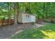 Backyard shed offers practical storage space, with easy access and surrounded by mature trees at 111 Wilton Pl, Mooresville, NC 28117