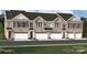 Beautiful brick townhomes feature attached garages, dark shutters and crisp white trim at 12037 Lavinia Ln, Charlotte, NC 28277