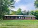 Charming one-story brick home with symmetrical design and a well-maintained lawn, surrounded by mature trees at 1207 Carlson Dr # 10, Monroe, NC 28110