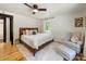 Cozy bedroom featuring a ceiling fan, a large bed with plush bedding, and a sitting area at 1207 Carlson Dr, Monroe, NC 28110