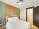 Simple bedroom with a modern white metal bed frame, natural wood headboard, and modern lighting at 1207 Carlson Dr, Monroe, NC 28110