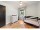Bedroom with a crib and dresser, hardwood floors, and natural light from a window at 1207 Carlson Dr, Monroe, NC 28110