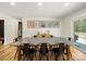 Bright dining room featuring a large table, artwork, and hardwood floors at 1207 Carlson Dr, Monroe, NC 28110