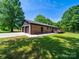 Exterior view of a brick house with an attached two-car garage and well-maintained lawn at 1207 Carlson Dr, Monroe, NC 28110