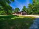 Exterior view of a well-kept brick home, a two-car garage, and a spacious front yard at 1207 Carlson Dr, Monroe, NC 28110
