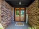 Inviting front entrance with double wooden doors and brick facade at 1207 Carlson Dr, Monroe, NC 28110