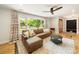 Bright living room with comfortable seating, large window, and hardwood floors at 1207 Carlson Dr, Monroe, NC 28110