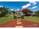 Scenic backyard featuring a cozy seating area and lush greenery, creating a tranquil outdoor retreat at 12802 Waterlyn Club Dr, Charlotte, NC 28278