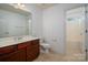 Bathroom features a single sink vanity with wood cabinets and a combined tub and shower at 12802 Waterlyn Club Dr, Charlotte, NC 28278