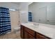 Bathroom features a single sink vanity with wood cabinets and a combined tub and shower at 12802 Waterlyn Club Dr, Charlotte, NC 28278