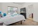 Bright bedroom with natural light from large window, TV, and ensuite bathroom at 12802 Waterlyn Club Dr, Charlotte, NC 28278