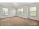 Bright and airy bedroom with three large windows and neutral carpet, offering ample natural light at 12802 Waterlyn Club Dr, Charlotte, NC 28278
