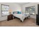 Bedroom with natural light from two large windows featuring neutral walls and carpeted floors at 12802 Waterlyn Club Dr, Charlotte, NC 28278