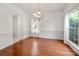 Inviting dining room with hardwood floors, decorative chandelier, and natural light enhances the home's appeal at 12802 Waterlyn Club Dr, Charlotte, NC 28278