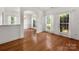 Elegant dining room with hardwood floors, bright windows, and wainscoting for a classic design at 12802 Waterlyn Club Dr, Charlotte, NC 28278