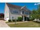 Charming two-story home with well-maintained lawn and lush landscaping offers great curb appeal at 12802 Waterlyn Club Dr, Charlotte, NC 28278