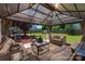 Inviting gazebo with plush seating, a perfect outdoor oasis for relaxation and entertaining at 12802 Waterlyn Club Dr, Charlotte, NC 28278