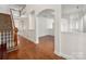 Spacious interior with hardwood floors, staircase, and arched doorways create an open and inviting atmosphere at 12802 Waterlyn Club Dr, Charlotte, NC 28278