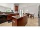 Kitchen features an island, stainless sink and adjacent breakfast nook with table at 12802 Waterlyn Club Dr, Charlotte, NC 28278