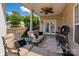 Covered patio with comfortable seating and a ceiling fan, perfect for relaxation and entertaining at 12802 Waterlyn Club Dr, Charlotte, NC 28278