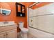 This bathroom offers an orange accent wall, cabinet storage, and a shower with sliding glass doors at 135 Meadow Lake Dr, Salisbury, NC 28146