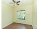 This bedroom features tan-colored walls, a neutral-colored ceiling fan and tile floors at 135 Meadow Lake Dr, Salisbury, NC 28146