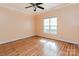 This bedroom features hardwood flooring, a window overlooking the backyard, and a ceiling fan at 135 Meadow Lake Dr, Salisbury, NC 28146