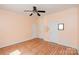 This bedroom has peach-colored walls and a ceiling fan and two entry doors at 135 Meadow Lake Dr, Salisbury, NC 28146